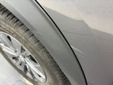 a close up of a car ' s side door and tire