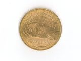 a close up of a gold coin on a white surface