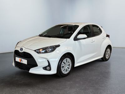 a white toyota yaris parked in a white room