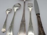 five spoons, a knife, and a fork on a table
