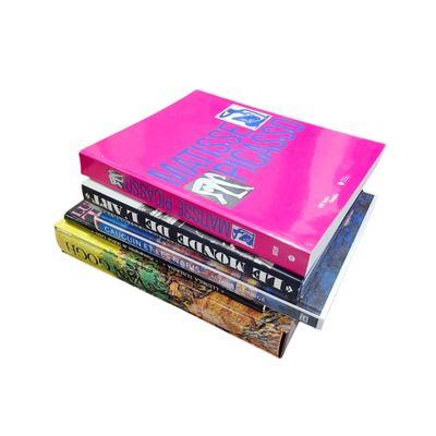 books stacked on top of each other on a white surface
