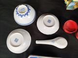 a table with a tray of tea cups and saucers on it