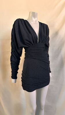 the mannequin is wearing a black dress on a white mannequin