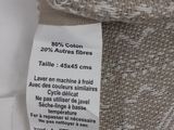 the label on the back of a chair shows that it is made from a piece of fabric