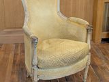 a yellow chair that is sitting on a wooden floor