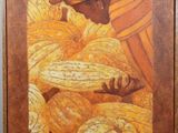 tableau représentant un homme coiffé d'un turban, debout devant un tas d'oranges