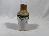 a white and gold vase with a green design on it