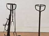 pair of wrought iron horse tacks on cast iron stands