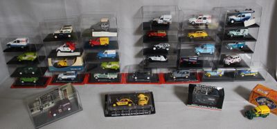 a lot of toy cars in a display case on a table