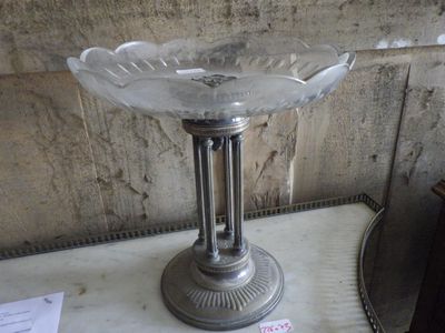 a glass bowl sitting on top of a table next to a mirror