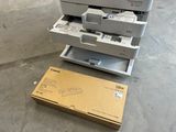 a printer sitting on top of a cart next to a box