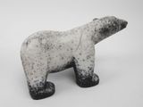 a black and white polar bear figurine on a white surface