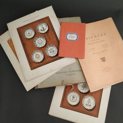 three books on a table with a clock and a book on top of it