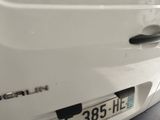 a close up of a white car with a number plate on it