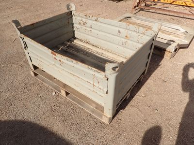 a small wooden box sitting in the middle of a dirt field