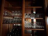 many glasses on the shelves in the room