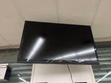 a flat screen tv hanging from the ceiling in a store
