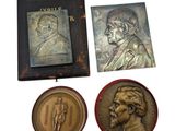 three medals and a book on a white background