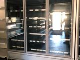 two refrigerators that are in the middle of a room