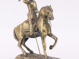 statue of a man on a horse with a flag on a white background