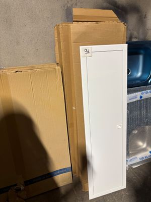a refrigerator and a refrigerator freezer in a room