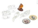a small collection of glass objects on a white surface