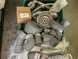 a green container filled with assorted items on the floor