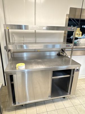 a large stainless steel kitchen with a sink and a counter