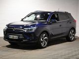 un 4x4 bleu garé dans un garage au sol en damier