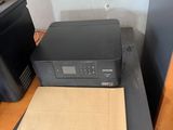 a printer sitting on top of a desk next to a printer