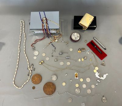 a lot of silver and gold jewelry on a table