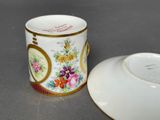 a small cup and saucer sitting on a table