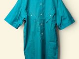 an image of a shirt hanging on a hanger on a wall