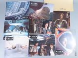 a lot of star wars movie posters on a table