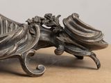 a metal sculpture of a dragon on a table