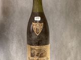 a bottle of wine that is sitting on a shelf