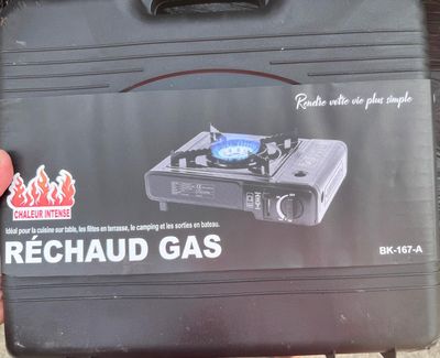 a black suitcase with a blue burner on top of it