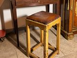 a small wooden stool sitting next to a small table