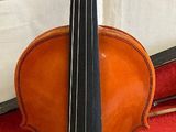 a violin that is sitting on top of a red case