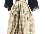 a woman ' s dress with a green and red plaid skirt