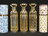 several different types of perfume bottles lined up on a black surface