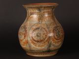 a vase that is sitting on a black surface