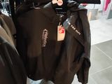 two jackets hanging on a rack in a clothing store