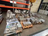 many pieces of metal on pallets in a warehouse