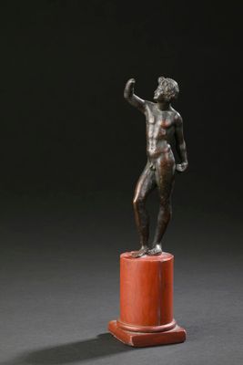 statue en bronze représentant un homme debout sur un socle, le bras levé