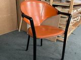 a chair that is sitting in a room next to a pile of boxes