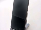 a cell phone that is on a stand on a table