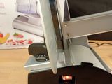 someone is using a knife to cut a piece of paper on a table