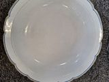 a bowl and a plate on the floor next to each other
