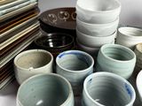many bowls and plates stacked on top of each other